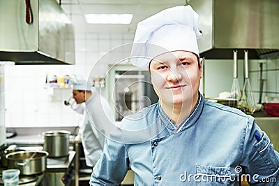 Cook chef at restaurant kitchen Stock Photo