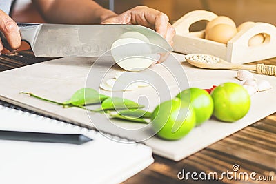 Cook is chopping onion, closeup shoot, slicing Stock Photo