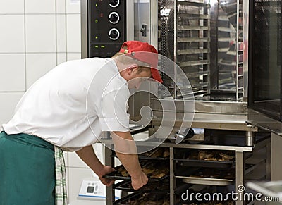 Cook at commercial stove Stock Photo