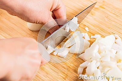 Cook cuts onions with a knife Stock Photo