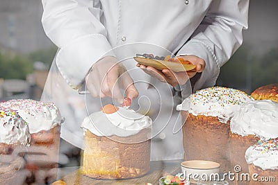 A cook decorates pastries in the dining room Stock Photo