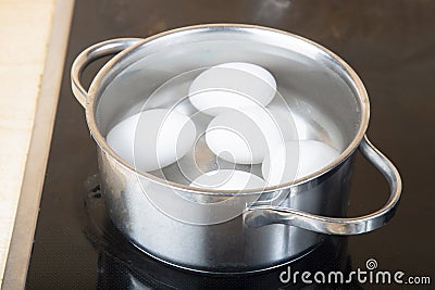 Cook the eggs on the kitchen stove. Cooking at home Stock Photo