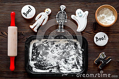 Cook halloween gingerbread cookies bat, skeleton, ghost. Sweets neat rolling pin and baking sheet. white background top Stock Photo