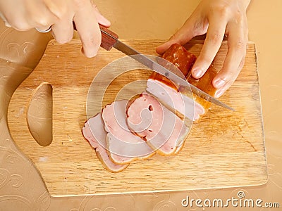 Cook hands cutting bacon Stock Photo