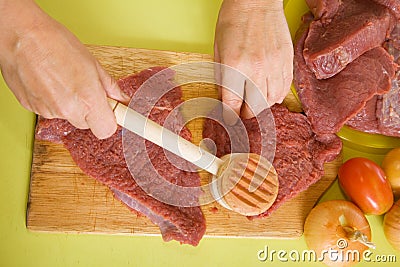 Cook hands making tenderized steak Stock Photo