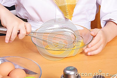 Cook hands whipping egg Stock Photo