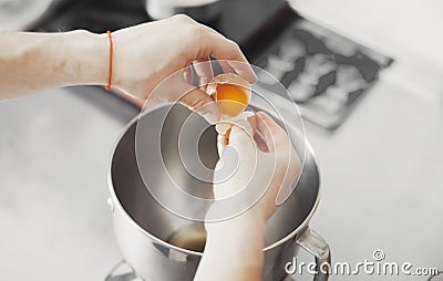 Cook pours egg in metal plate Stock Photo
