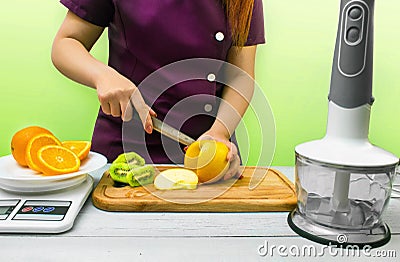 A cook slicing fruits for making juice Stock Photo