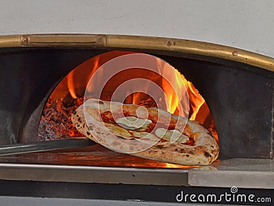 Cook taking out baked pizza Stock Photo