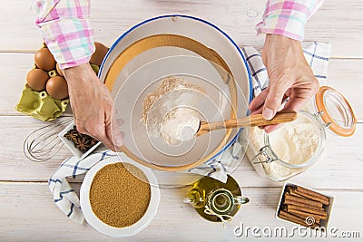 Cook woman sieving flour with her hands Stock Photo