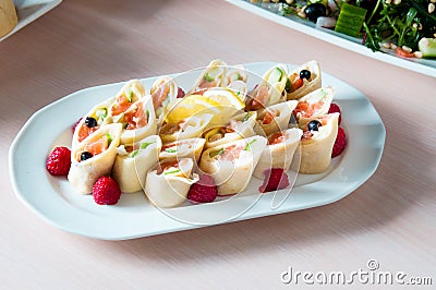 Cooked apetit dish beautifully decorated in a plate on a wooden table, natural light Stock Photo