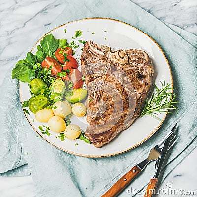 Cooked beef tbone steak with vegetables and rosemary, square crop Stock Photo