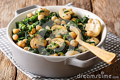 Cooked diet chickpeas with spinach and champignons close-up in a Stock Photo