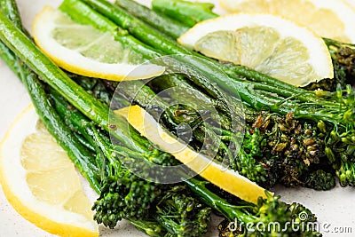 Cooked fresh broccolini with lemon on the plate Stock Photo
