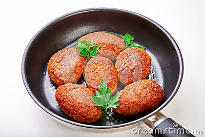 Cooked fried cutlets in pan isolated on white background Stock Photo