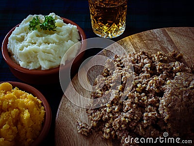 Haggis, with mashed potatoes, mashed swede and a wee dram of Scotch whiskey. Burns Night, Scotland Stock Photo