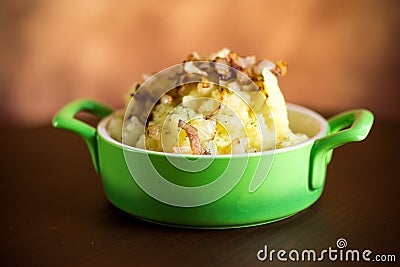 Cooked mashed potatoes with fried chopped bacon and onions. Stock Photo