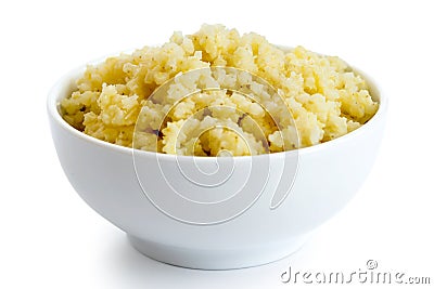 Cooked millet in white ceramic bowl. Stock Photo