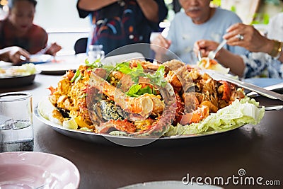 Cooked mixed seafood, lobster shrimp, alaskan king crab in large plate for family party Stock Photo