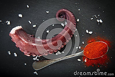 Cooked octopus over a slate plate decorated Stock Photo