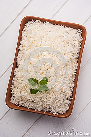 Cooked plain white basmati rice in terracotta bowl, selective focus Stock Photo