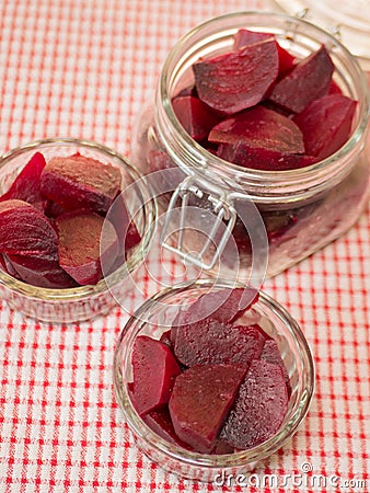Cooked red slices beetroot in plate and glass bowls Stock Photo