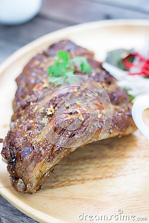 Cooked ribs pork barbeque on wooden plate Stock Photo