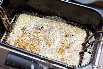 Cooked shrimp in deep fryer close up Stock Photo