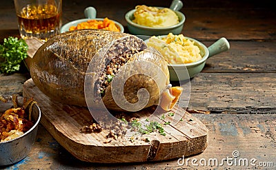 Cooked sliced open haggis and vegetables Stock Photo