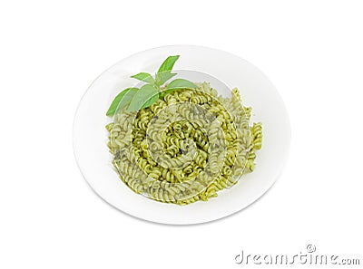 Cooked spiral pasta with sauce pesto on white dish Stock Photo