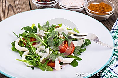 Cooked squid, fresh arugula, tomatoes, oil, spices