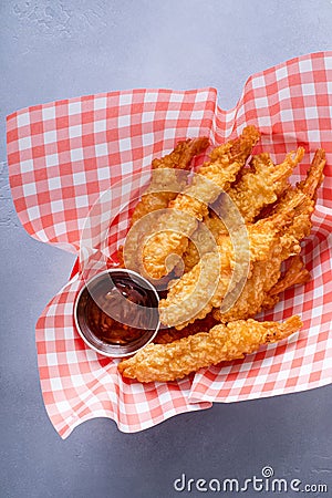 Cooked tempura shrimp in a basket with dipping sauce Stock Photo