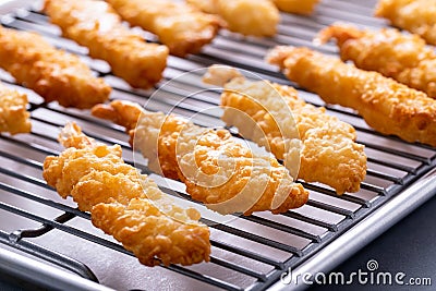 Cooked tempura shrimp on a cooling rack Stock Photo