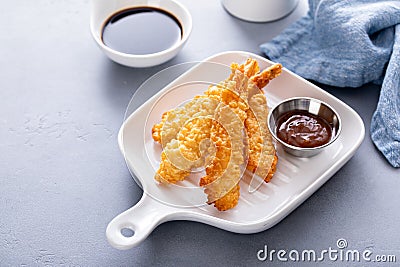 Cooked tempura shrimp on a plate with dipping sauce Stock Photo