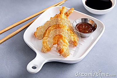 Cooked tempura shrimp on a plate with dipping sauce Stock Photo