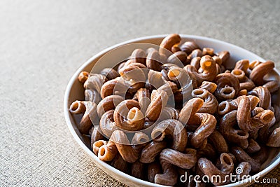 Cooked Whole Wheat Brown Pasta made with grape seeds Stock Photo