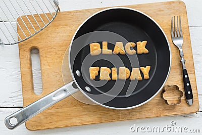 Cookie biscuits word BLACK FRIDAY in frying pan Stock Photo