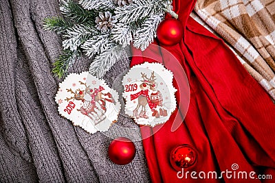 Cookie with deers and numbers 2019 on the background with fir branches and red balls, top view. Holiday sweets. New Year`s and Ch Stock Photo