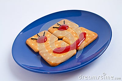 Cookie smile on blue plate Stock Photo