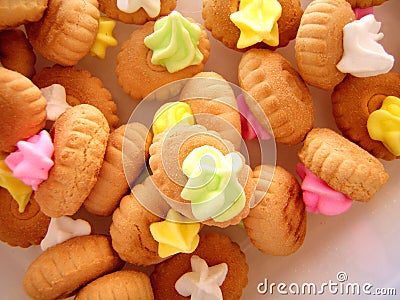 Cookies with colorful cream on top. Stock Photo