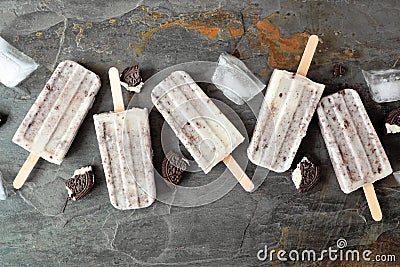 Cookies and cream popsicles over a dark background Stock Photo