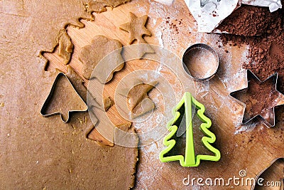 Cookies forms and gingerbread dough on wooden pastry board Stock Photo