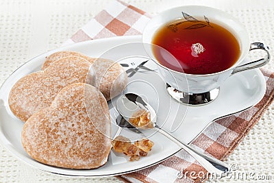 Cookies heart shape, brown sugar, spoon, black tea Stock Photo