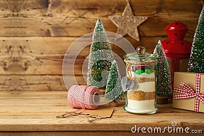 Cookies ingredients with colorful candies in jar on wooden table. Handmade Christmas gift concept Stock Photo
