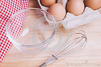 Cookies ingredients. Flour, eggs in carton, eggbeater,eggshells Stock Photo