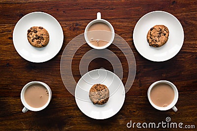 Cookies placed on plates and cups filled with drinking chocolate Stock Photo