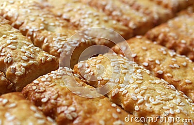 Cookies sticks sprinkled with sesame seeds are spread out on the table Stock Photo