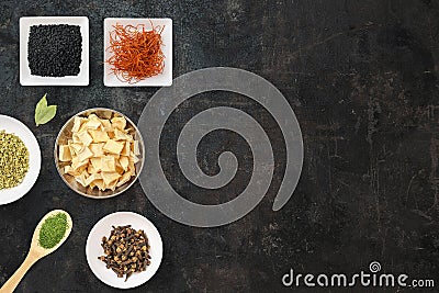 Cooking background with plates with different types of spices. Asian spices like curry, pepper and paprika on white spoon. Top Stock Photo