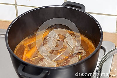 Cooking beef roulade in sauce. german beef rolls in pot. Stock Photo