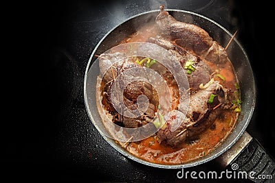 Cooking beef roulades, german stuffed meat rolls with vegetables Stock Photo